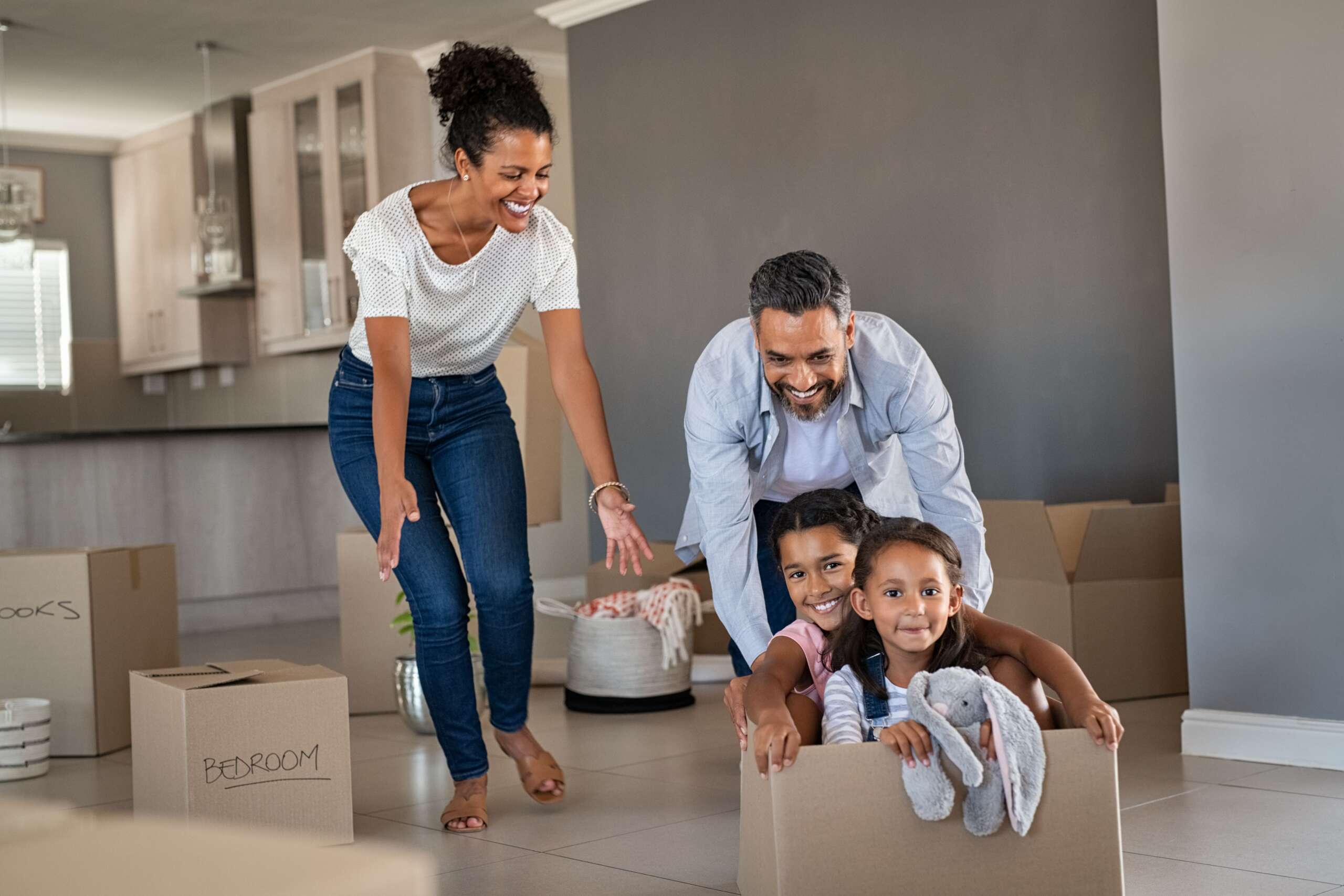 parents playing with children while moving into ne dcbzrvx min